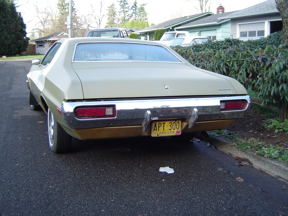 1973 Ford Torino, tan and gold, parked on street, rear view
