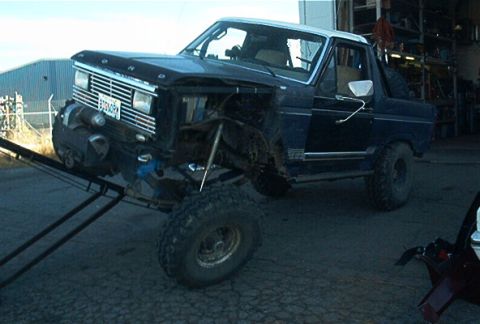 1986 Ford Bronco - This 1986 Ford Bronco features a lifted suspension and off-road tires, seen partially on a ramp.