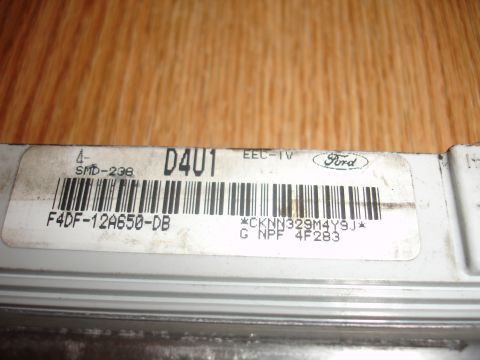 1993 Ford Taurus - Close-up of a Ford engine control module, showing its part number and barcode.