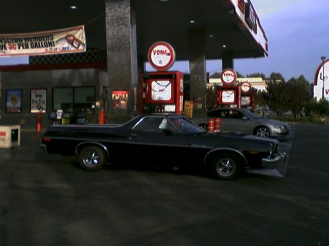 1973 Ford Ranchero - A black 1973 Ford Ranchero is parked at a Vons gas station, with another car visible in the background.