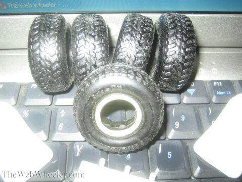 1968 Ford Mustang - Toy tires are shown piled on a laptop keyboard, with no visible vehicle or year identification.