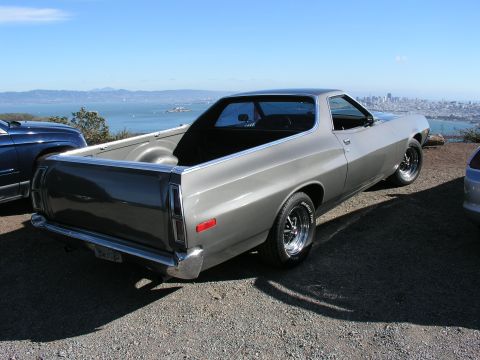 1972 Ford Ranchero - This 1972 Ford Ranchero is seen from a three-quarter front view, parked with a scenic bay and city skyline in the background.