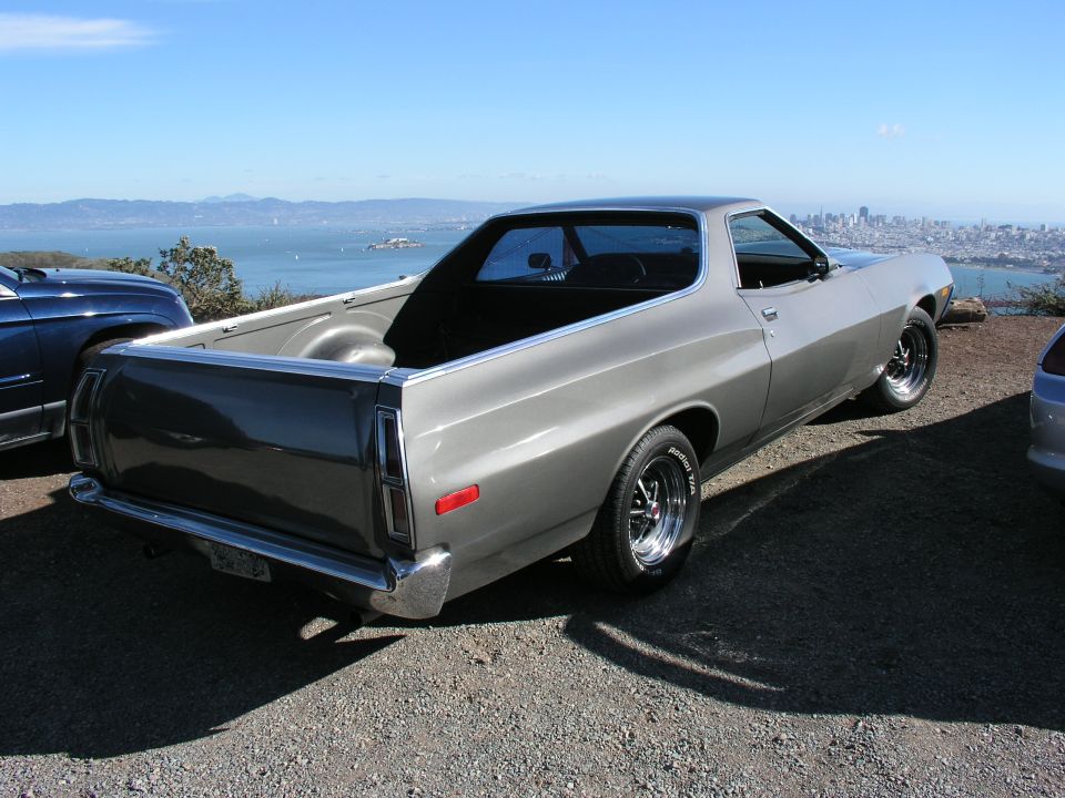 Gray 1972 Ford Ranchero with a two-tone paint job parked overlooking a bay