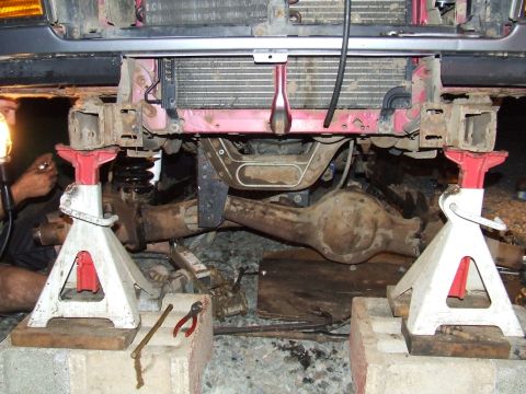 1995 Ford Bronco - The vehicle's frame and suspension are visible from the front, supported by jack stands.