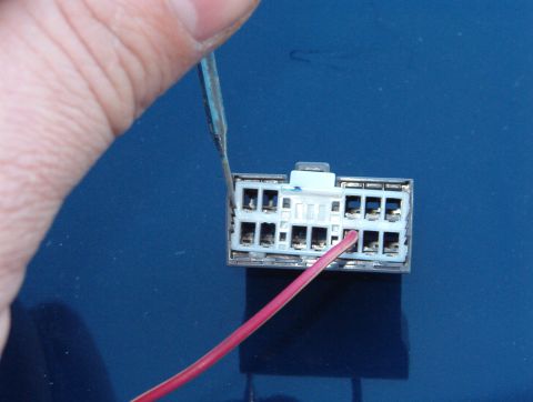 1999 Ford Crown Victoria - Using a small flat screwdriver, pry one side free, and while holding upward pressure on the top white tab, rotate the screwdriver blade so…