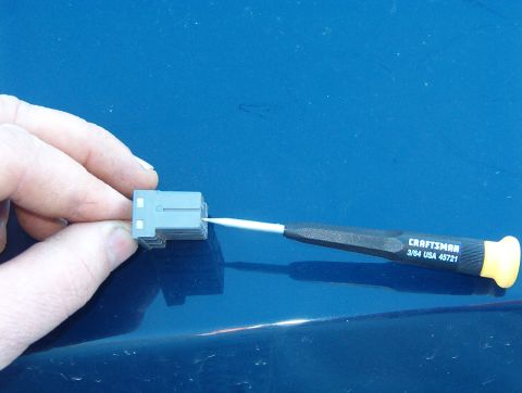 1999 Ford Crown Victoria - Holding slight inward pressure, pry the pawl up.