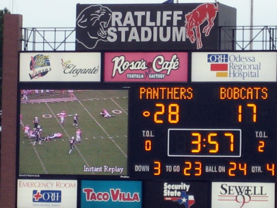 Scoreboard displaying football game information with team names Panthers and Bobcats, scores 28-17, and game time 3:57
