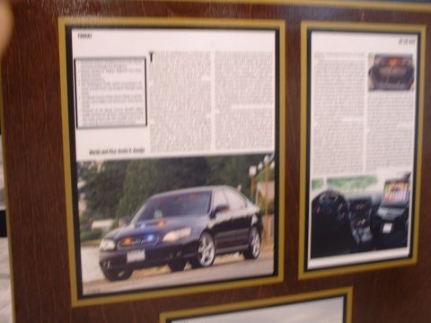 2000 Ford Crown Victoria - A dark sedan, possibly a police vehicle, is shown with lights on the dashboard.