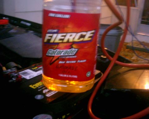 1994 Ford Probe - A bottle of Fierce Gatorade oil is placed on a car battery, with some wiring visible.