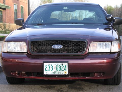 1991 Ford LTD Crown Victoria - This maroon Ford Crown Victoria is shown from the front, displaying its black grille and a New Hampshire license plate.