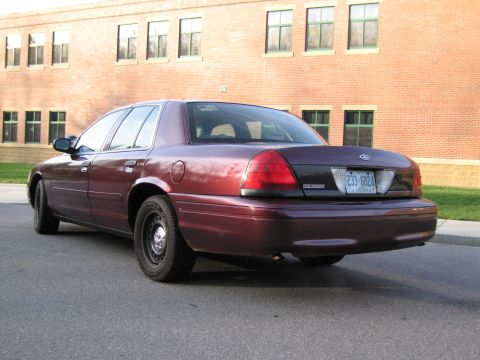 1991 Ford LTD Crown Victoria - 1991 Ford Crown Victoria LTD parked on asphalt in front of a brick building.