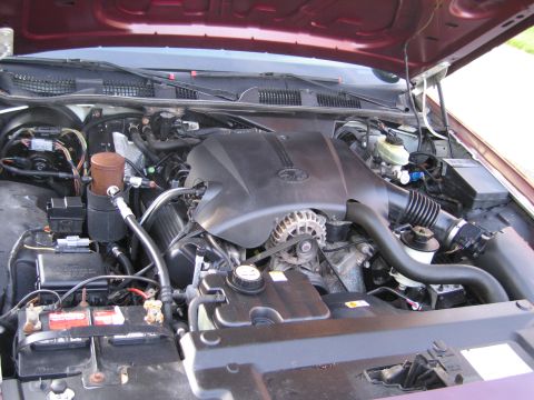 1991 Ford LTD Crown Victoria - The engine compartment of a Ford Crown Victoria, displaying its V8 engine and associated parts.