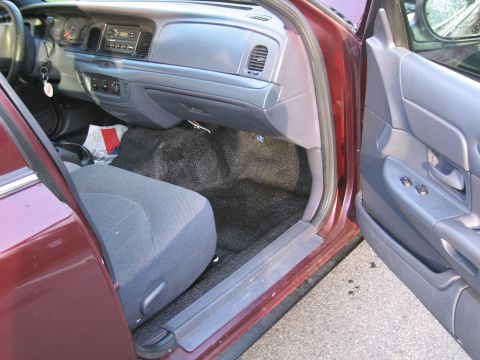 1991 Ford LTD Crown Victoria - Interior view of a maroon sedan, showing the driver's seat and dashboard.