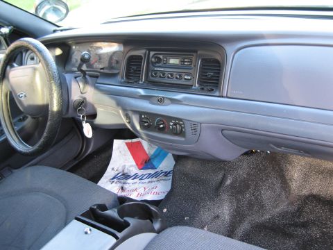 1991 Ford LTD Crown Victoria - The interior of a car, the dashboard, steering wheel, and a floor mat from Valvoline.