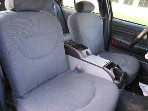 1991 Ford LTD Crown Victoria - Interior view of a car's front seats and center console, showing fabric upholstery and cup holders.