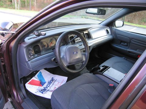 1991 Ford LTD Crown Victoria - The interior of a 1991 Ford Crown Victoria LTD, a dashboard with gauges and a Ford steering wheel.