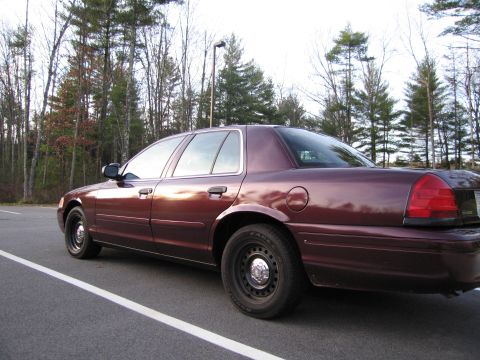 1991 Ford LTD Crown Victoria - Rear quarter view of a maroon 1991 Ford Crown Victoria LTD parked on asphalt.