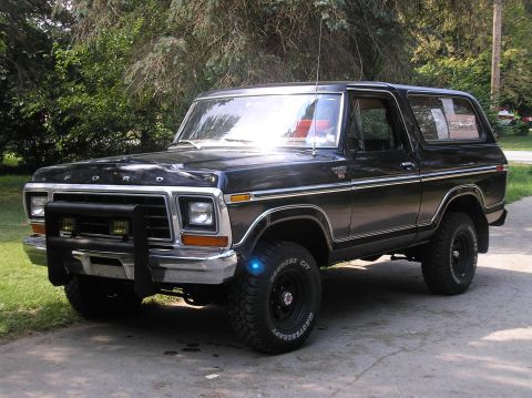 1978 Ford Bronco - This 1978 Ford Bronco is shown from a 3/4 front angle, parked on a driveway with trees in the background.