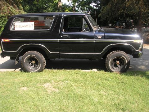 1978 Ford Bronco - Side view of a black 1978 Ford Bronco with a 'For Sale' sign in the window.