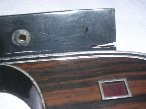 1975 Ford Ranchero - Close-up view of a dashboard trim piece wood grain and a small red indicator light.