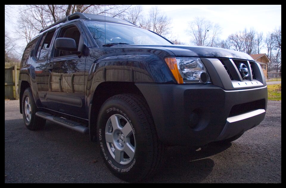 Dark blue Nissan Xterra parked outdoors, front passenger side visible