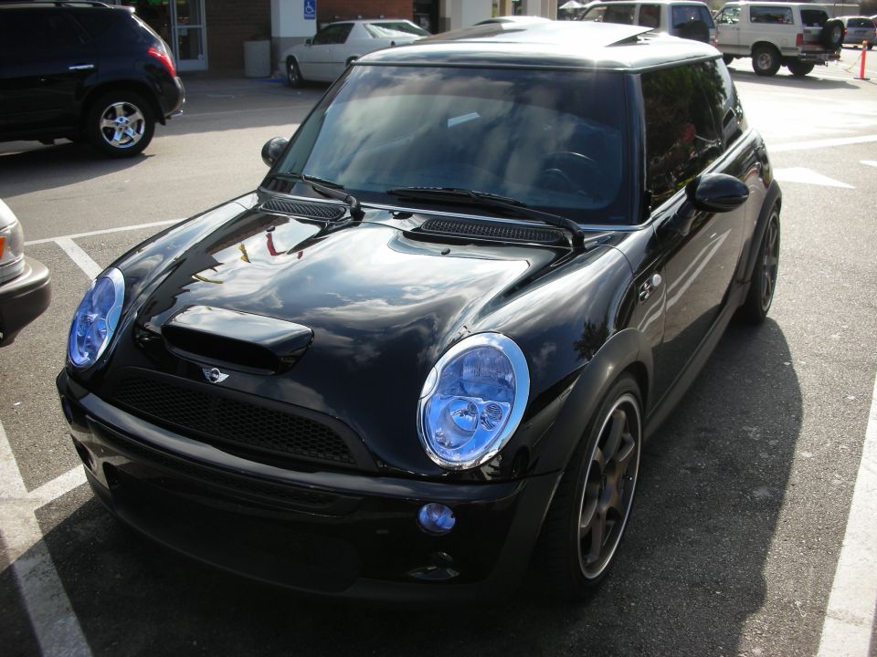 Black Mini Cooper S with hood scoop, sunroof and bronze wheels, front view
