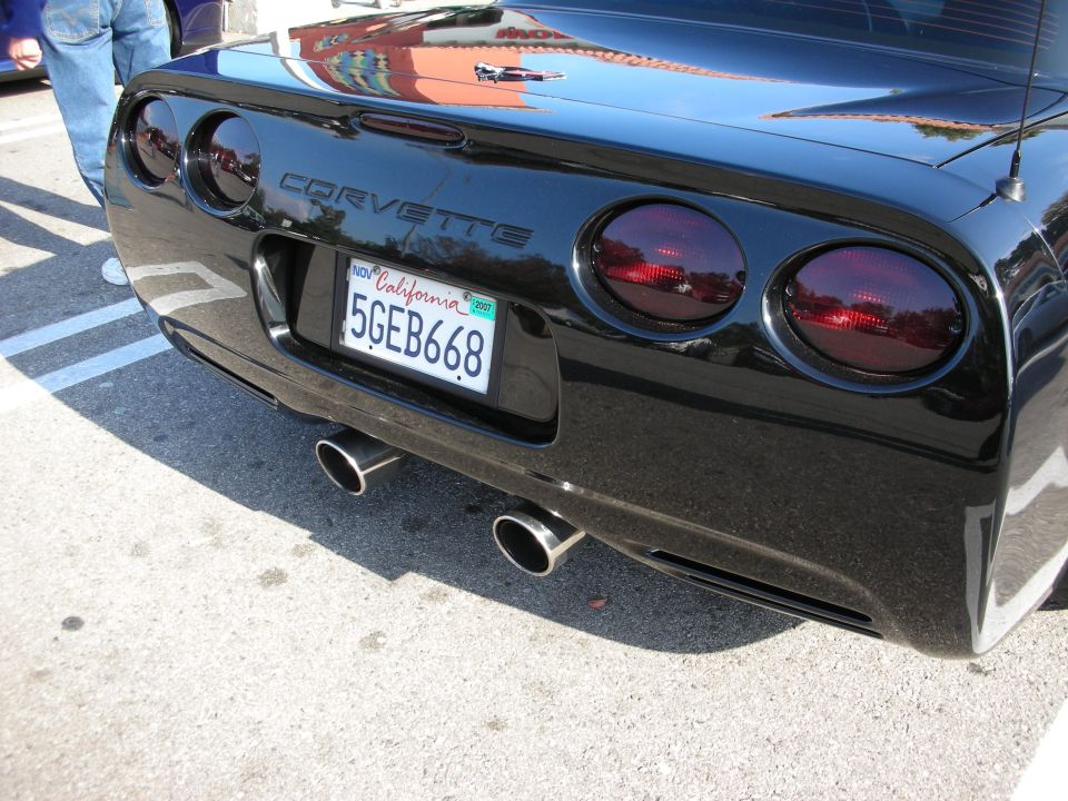 Rear bumper of black Corvette with California plate 5GEB668 and dual exhaust tips