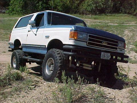 1990 Ford Bronco - This lifted Ford Bronco has a two-tone paint scheme and aggressive off-road tires.