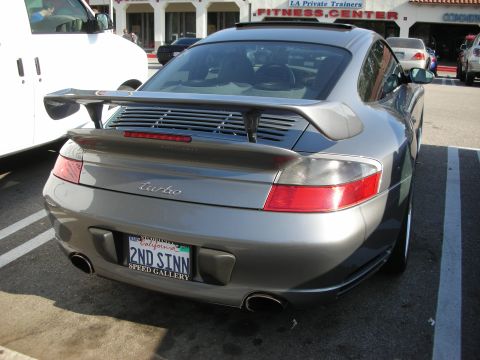1998 Ford Crown Victoria - rear of a gray Porsche 911 Turbo (996) with a fixed wing and California plate reading 2ND STNN.