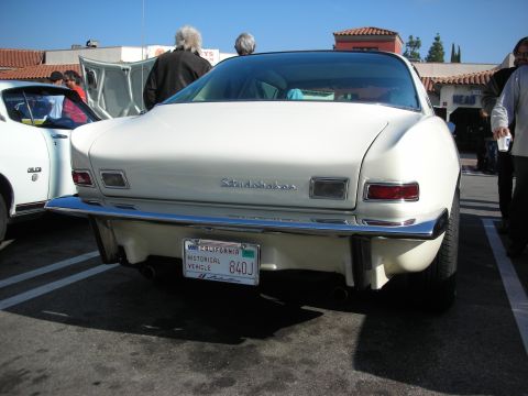 1998 Ford Crown Victoria - Rear view of a white Studebaker Avanti coupe showing its name badge, round taillights, and a California Historical Vehicle plate '840J'.