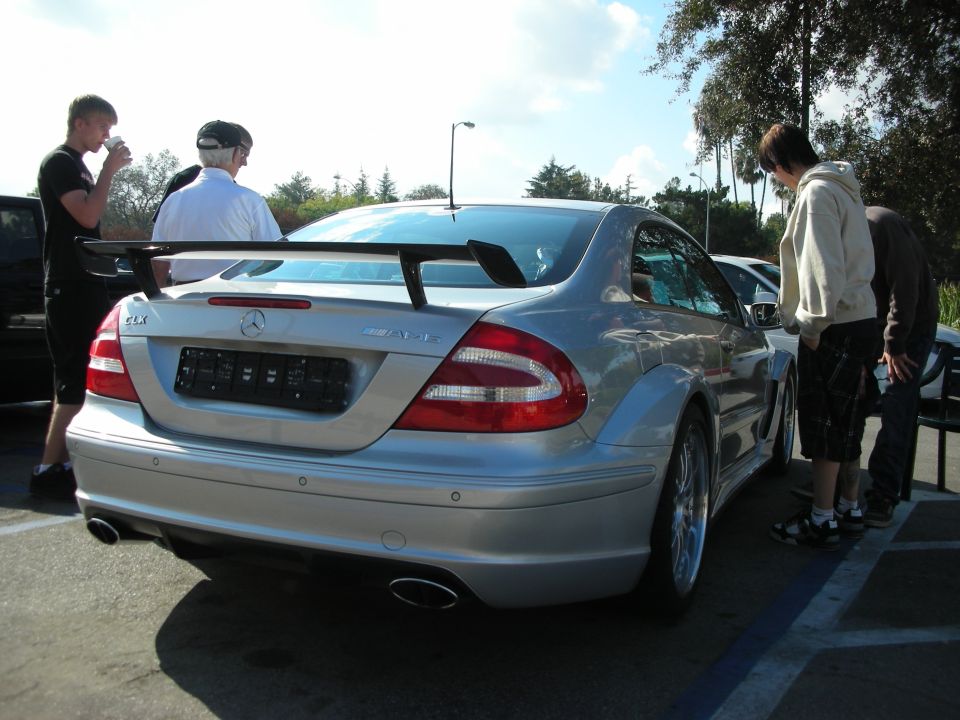 Rear of a silver Mercedes-Benz CLK DTM AMG coupe with large rear wing