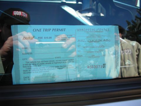 1998 Ford Crown Victoria - DMV One Trip Permit form in a windshield; a registration permit not matching any technical-document type.