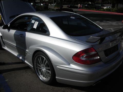 1998 Ford Crown Victoria - Rear quarter view of a silver Mercedes CLK coupe fitted with a rear spoiler, hood raised, parked at a car meet.