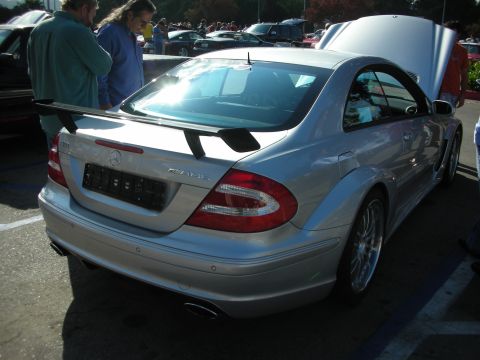 1998 Ford Crown Victoria - Rear view of a silver Mercedes-AMG CLK coupe with a trunk-mounted wing and dual exhaust at a car show.