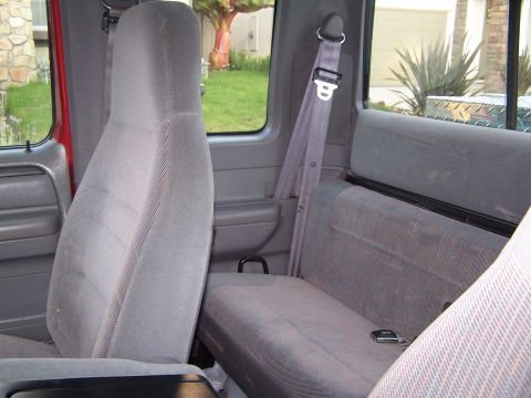 1997 Ford F-250 - The interior of a 1997 Ford F-250 pickup truck features gray cloth seats and seatbelts.