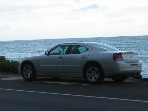 2006 Dodge Charger - A silver 2006 Dodge Charger is parked on the side of a road with the ocean in the background.
