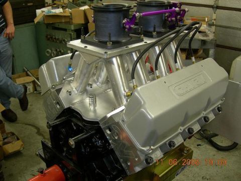 1972 Ford Ranchero - A custom V8 engine assembly sits on a stand in a workshop, with a timestamp of 11.06.2006.