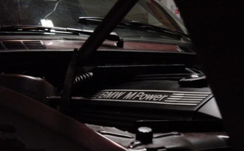 1984 BMW 3 Series - Close-up of the engine bay, highlighting the 'BMW M Power' inscription on the engine cover.