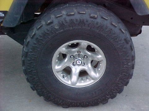1990 Ford Bronco - Close-up of a 1990 Ford Bronco's tire and wheel assembly.