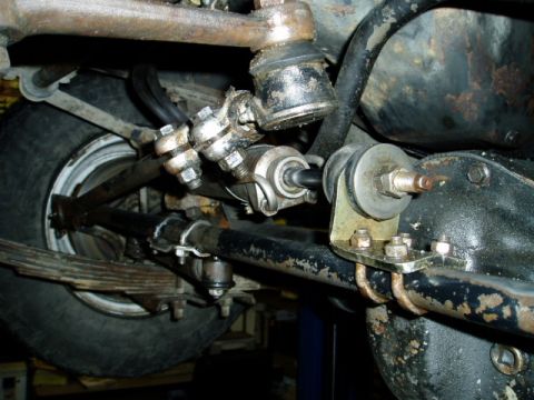 2000 Ford E350 - Close-up view of the steering and suspension components on a vehicle's undercarriage.