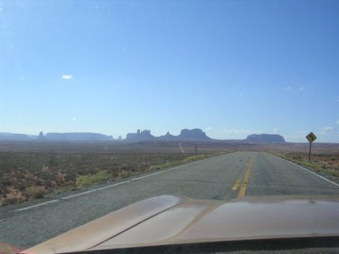 1975 Ford Ranchero - Driving through a desert landscape with iconic mesas under a clear blue sky.