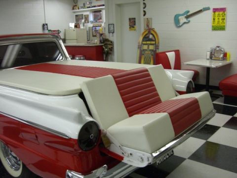 1957 Ford Ranchero - Custom 1957 Ford Ranchero features a bench seat installed in the bed, set against a diner backdrop.