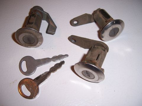 1983 Ford Bronco - Set of car door lock cylinders and keys. One key is marked 'MADE IN GERMANY'.
