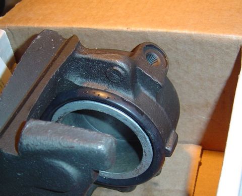 1986 Ford Bronco - A close-up view of a brake caliper, likely a replacement part, is shown inside its packaging.
