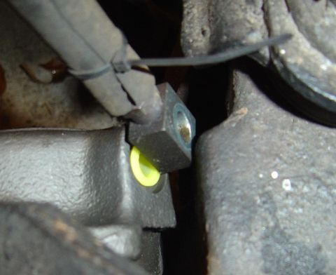 1986 Ford Bronco - Brake line fitting secured with a zip tie to a vehicle part.