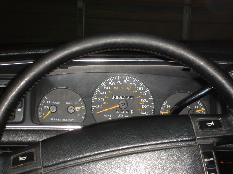 Dashboard with speedometer, fuel gauge, and voltmeter. Odometer shows 168,353 miles
