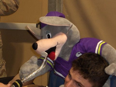 1996 Ford Probe - A person in a Chuck E. Cheese mascot costume appears to be interacting with someone, holding a microphone near their head.