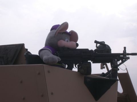 1996 Ford Probe - A plush toy resembling Chuck E. Cheese is positioned in a military vehicle, holding a machine gun.