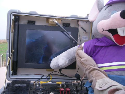 1996 Ford Probe - A plush character interacts with a monitor displaying a dark, outdoor scene.
