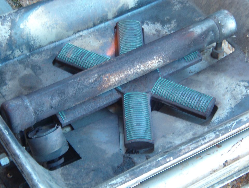It doesn't look very different because it's so efficient, but it's really putting out some heat.  This is with the flame valve WIDE open & the air valve adjusted to match.  It sounds like a jet engine - my friends nicknamed it "The Afterburner".

It's not very noticeable in the pic, but in addition to the bright teal-blue flames along each slot, there's also a larger flame standing about 2" above each arm of the burner.